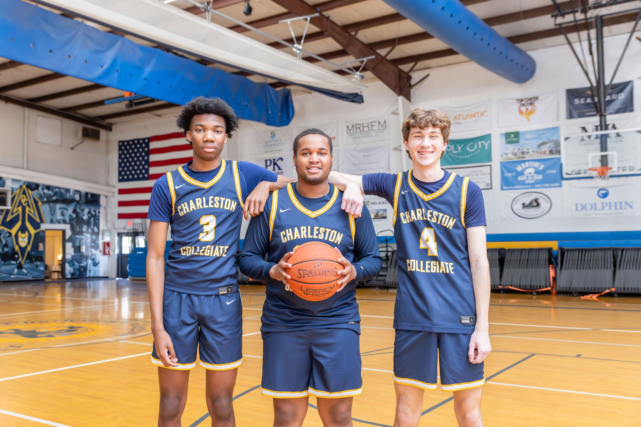 Charleston Collegiate Varsity basketball players pose for a photo in the gym. 