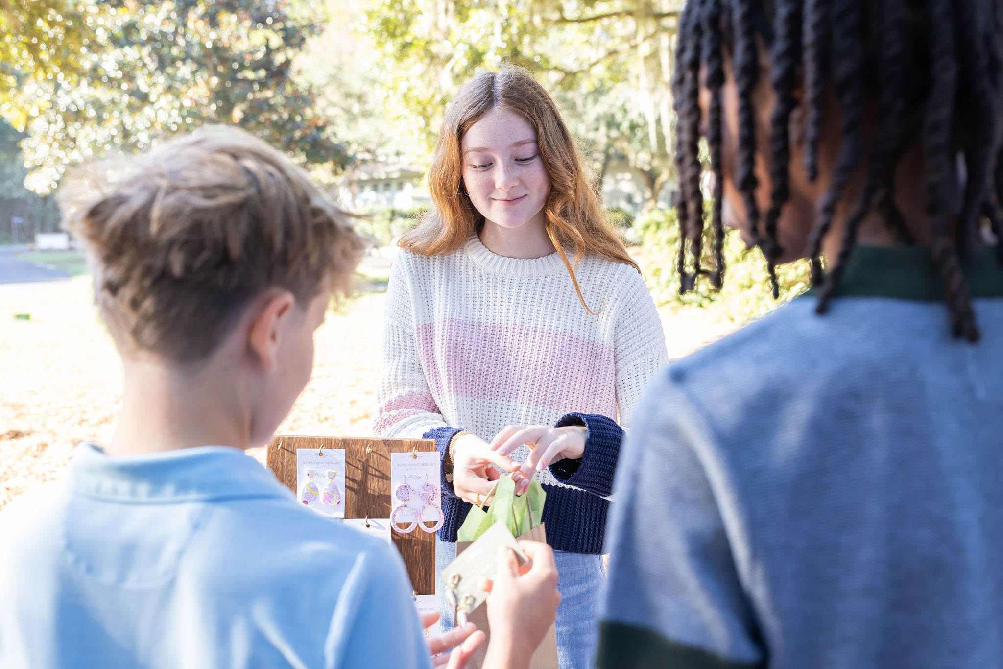 Student entrepreneurs at a market table. 