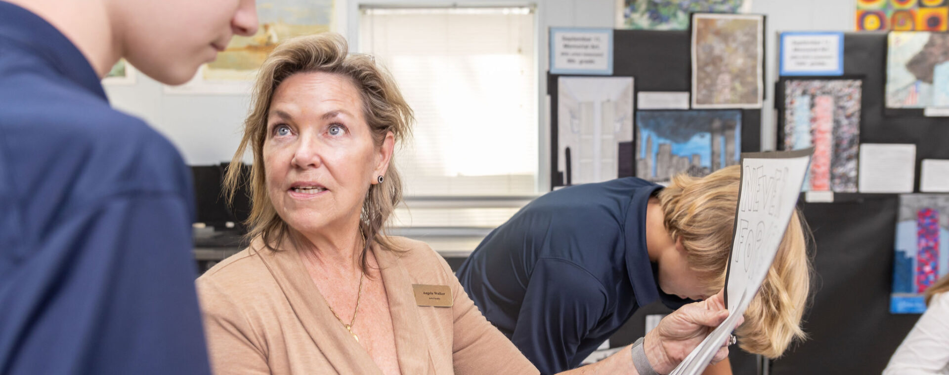 A teacher discussing an assignment with a student.