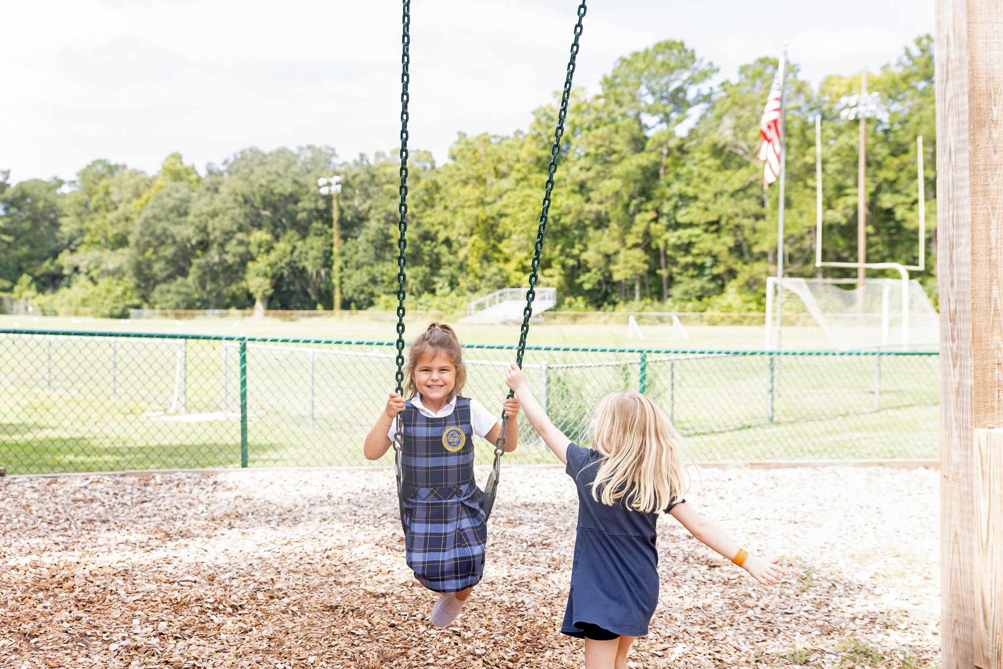 Students swinging on the playground.