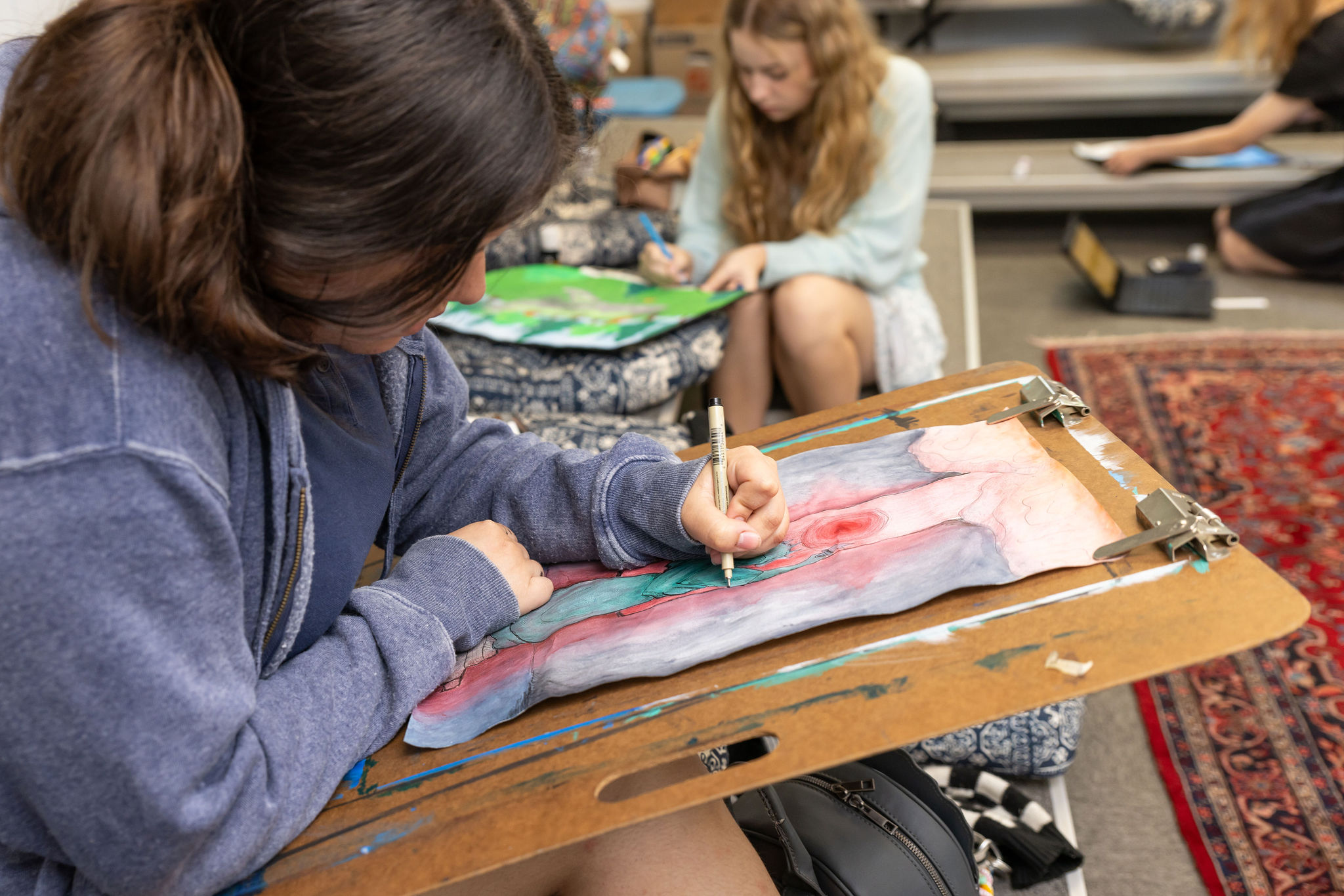 A student working on a drawing during art class.