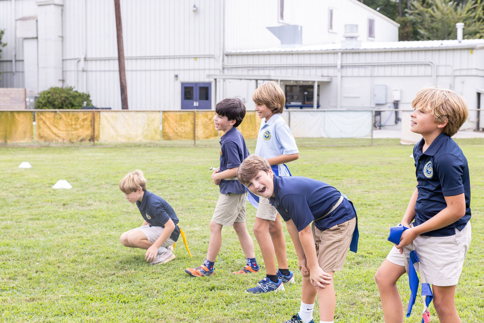 Students playing outside on the soccer field.
