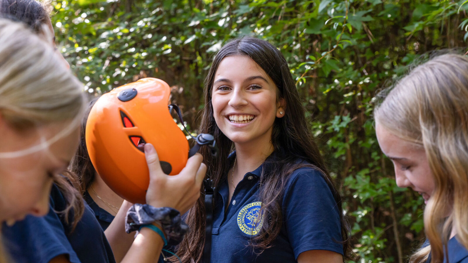 A smiling student in the Outdoor Education area of campus.