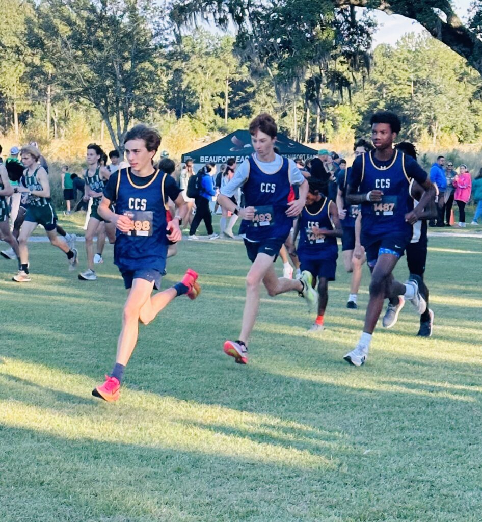 Students running during a cross country meet.
