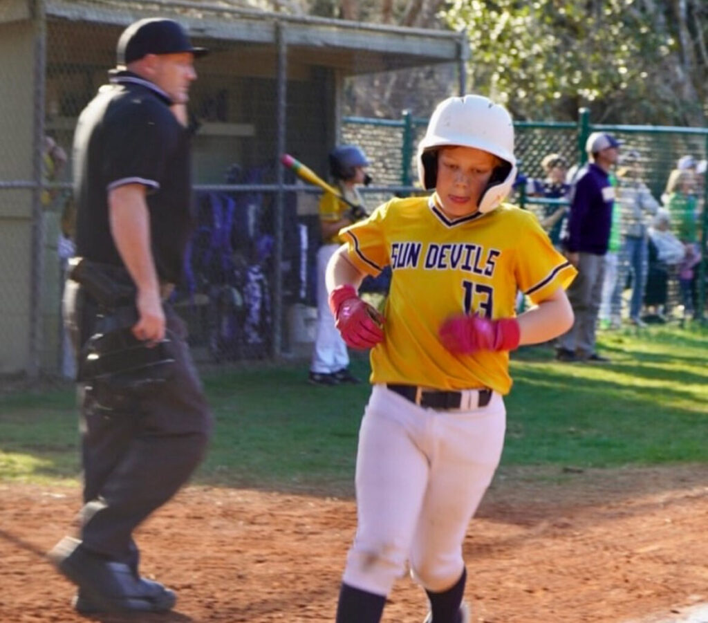 Charleston Collegiate student running the bases during a baseball game.