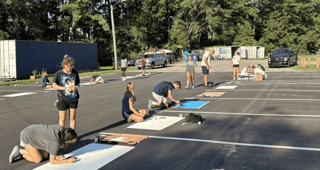 Seniors painting parking spots.