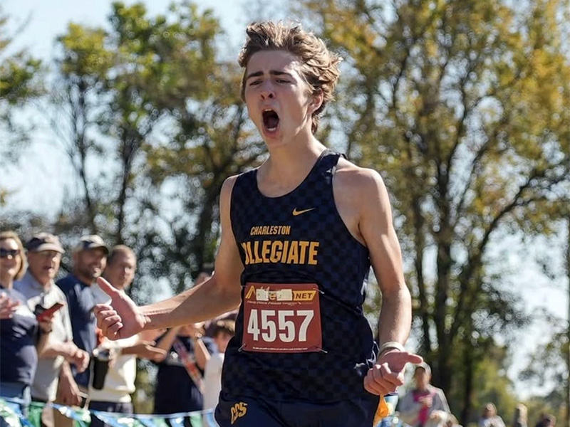 A runner celebrating after a cross country race.
