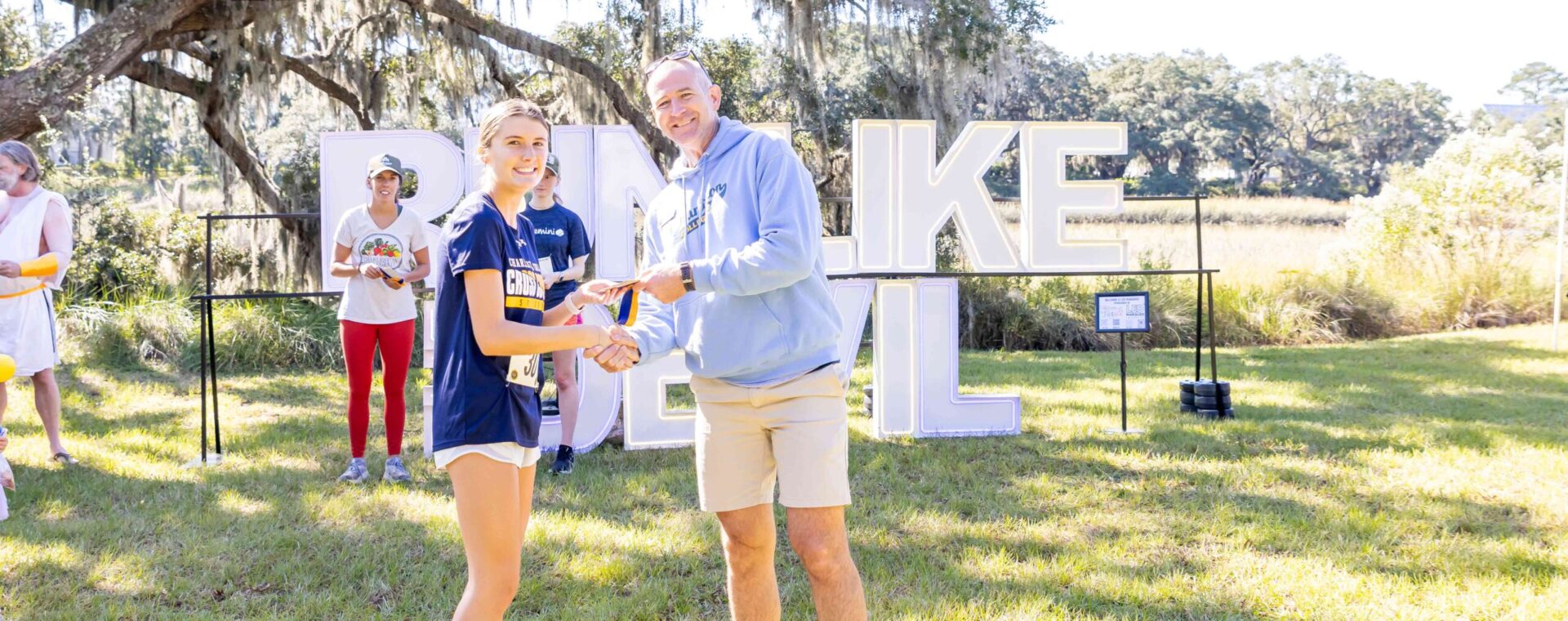 Head of School Andy Gyves distributes awards at Run Like the Devil 5k at Kiawah River.