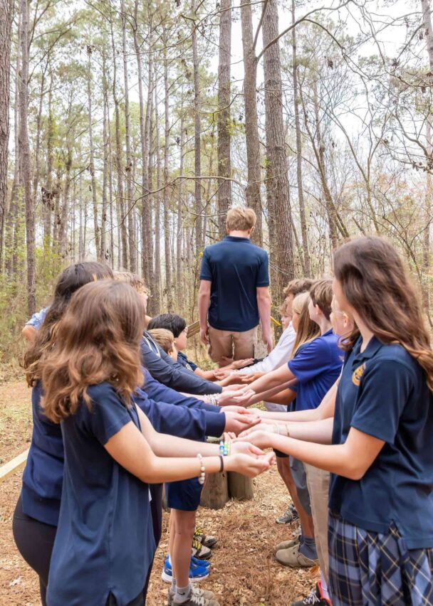 Students doing a trust fall.