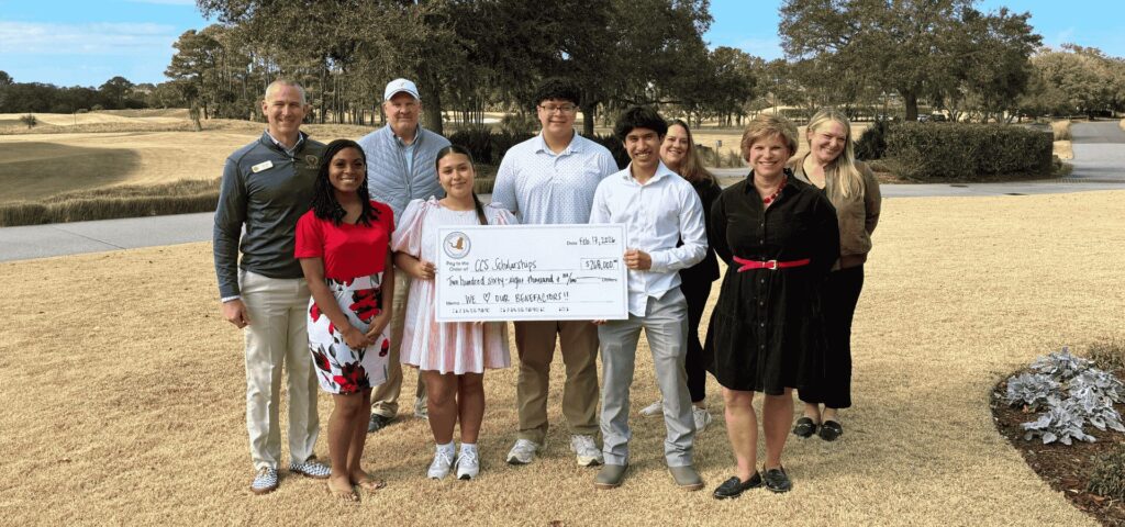 Students and adults with a presented check during the McNair Invitational at Briars Creek golf course.