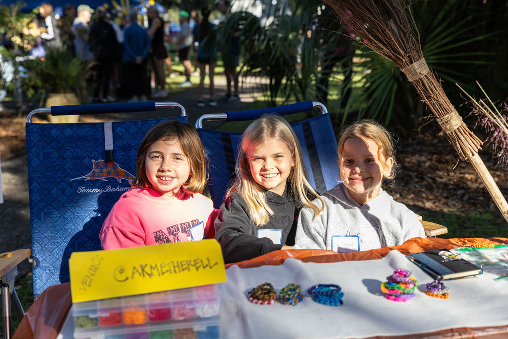 CCS students running an entrepreneur table with custom made jewelry at a fall festival.