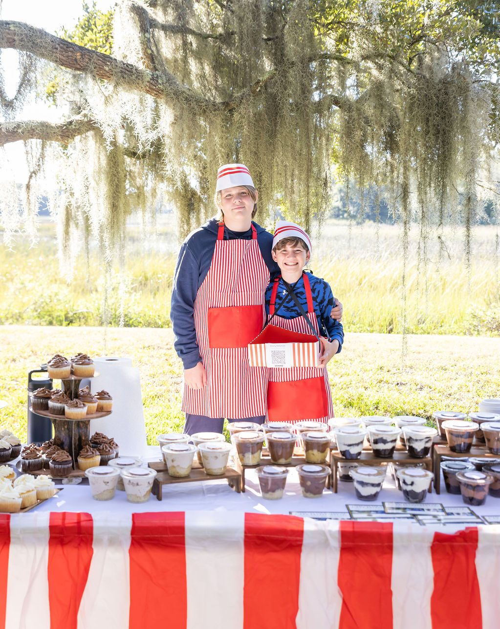 Students run their own business and vendor table at a fall festival.