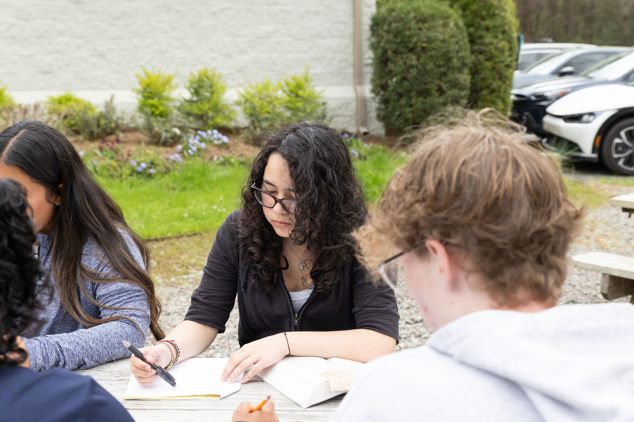 Students doing coursework outside. 