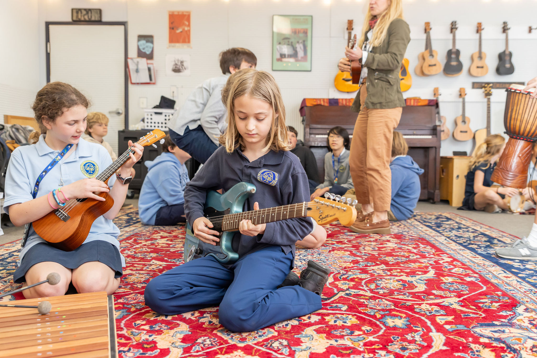 Students play instruments during music, movement, and drama class.