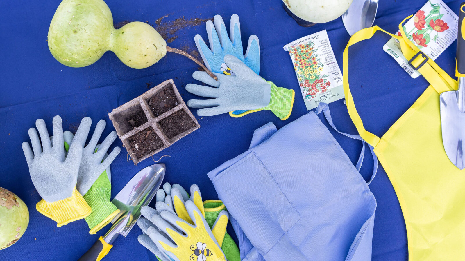 Students display their garden supplies on a table. 